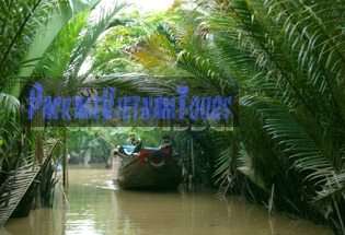 Boat traveling through water coconut forest at My Tho Tien Giang